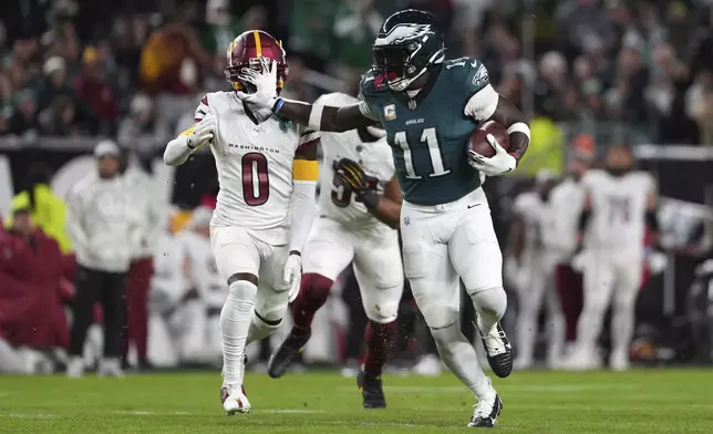 Philadelphia Eagles wide receiver A.J. Brown (11) runs past Washington Commanders cornerback Mike Sainristil (0) for a first down during the first half of an NFL football game Thursday, Nov. 14, 2024, in Philadelphia. (AP Photo/Matt Slocum)