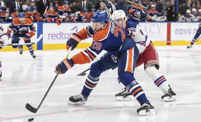 New York Rangers' Jacob Trouba (8) chases Edmonton Oilers' Leon Draisaitl (29) during second period NHL action in Edmonton on Saturday, November 23, 2024. (Jason Franson/The Canadian Press via AP)