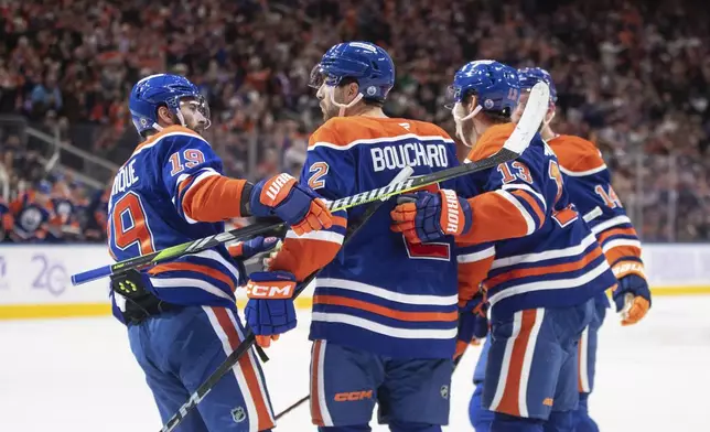 Edmonton Oilers' Adam Henrique (19), Evan Bouchard (2), Mattias Janmark (13) and Mattias Ekholm (14) celebrate a goal against the New York Rangers during second period NHL action in Edmonton on Saturday, November 23, 2024. (Jason Franson/The Canadian Press via AP)