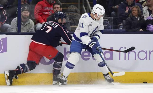 Tampa Bay Lightning forward Mitchell Chaffee, right, passes the puck in front of Columbus Blue Jackets forward Justin Danforth during the first period of an NHL hockey game in Columbus, Ohio, Thursday, Nov. 21, 2024. (AP Photo/Paul Vernon)