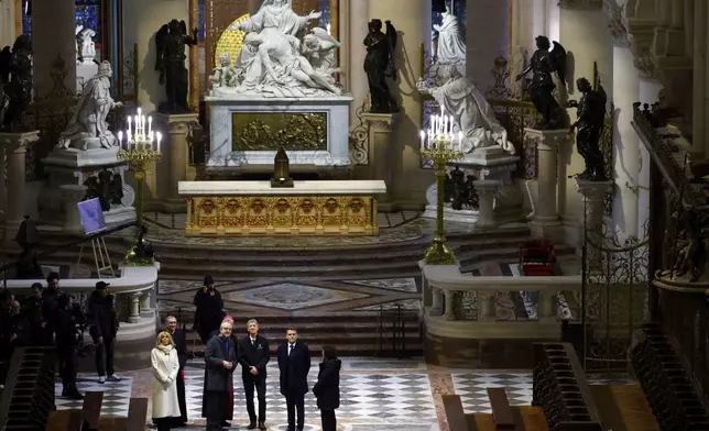 French President Emmanuel Macron, second right, and his wife Brigitte Macron visit the restored interiors of the Notre-Dame de Paris cathedral, Friday, Nov. 29, 2024 in Paris. (Sarah Meyssonnier/Pool via AP)