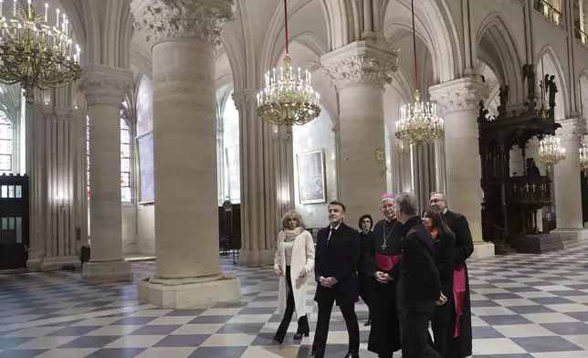 French President Emmanuel Macron, second left, and his wife Brigitte Macron, left, visit the restored Notre-Dame Cathedral, Friday, Nov.29, 2024 in Paris. (Christophe Petit Tesson, Pool via AP)