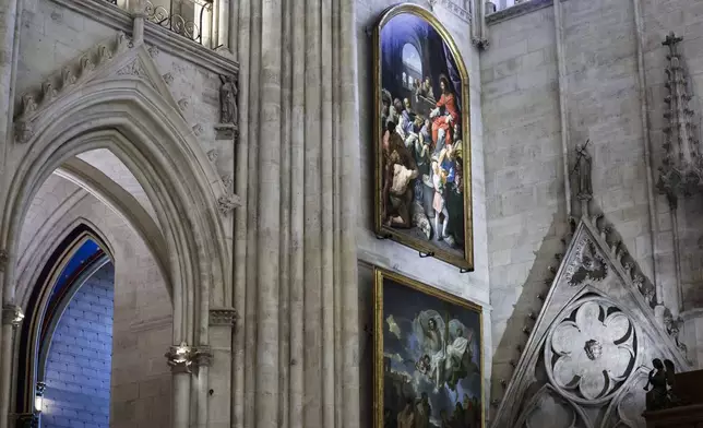 Paintings are seen inside Notre-Dame de Paris cathedral while French President Emmanuel Macron visits the restored interiors of the monument, Friday Nov. 29, 2024, in Paris. (Stephane de Sakutin, Pool via AP)