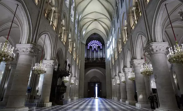 The nave, the western Rose stainless window and the organ of Notre-Dame de Paris cathedral are seen while French President Emmanuel Macron visits the restored interiors of the monument, Friday Nov. 29, 2024, in Paris. (Stephane de Sakutin, Pool via AP)