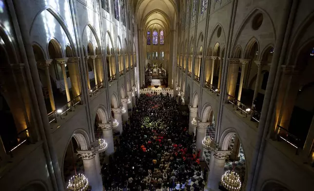 French President Emmanuel Macron delivers a speech to construction workers inside the Notre-Dame de Paris cathedral after visiting the restored interiors of the monument, Friday, Nov. 29, 2024 in Paris. (Sarah Meyssonnier/Pool via AP)