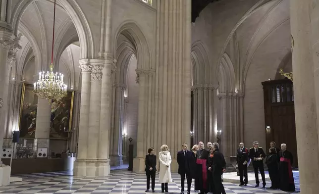 French President Emmanuel Macron, third left, and his wife Brigitte Macron, second left, visit the restored Notre-Dame Cathedral, Friday, Nov.29, 2024 in Paris (Christophe Petit Tesson, Pool via AP)