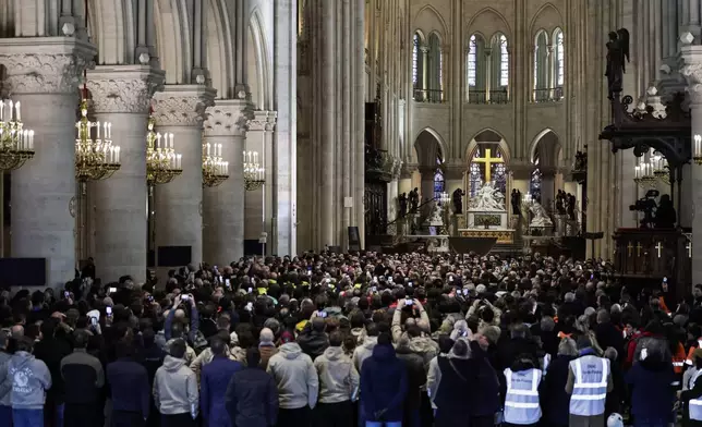 French President Emmanuel Macron delivers a speech to construction workers inside the Notre-Dame de Paris cathedral after visiting the restored interiors of the monument, Friday, Nov. 29, 2024 in Paris. (Stephane de Sakutin/Pool via AP)