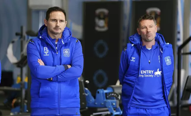 New Coventry City manager Frank Lampard, left and and new first team coach Chris Jones meet the team players, at Ryton Training Ground, Coventry, England, Thursday, Nov. 28, 2024. (Bradley Collyer/PA via AP)