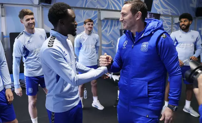 New Coventry City manager Frank Lampard, right, meets player Fabio Tavares, at Ryton Training Ground, in Coventry, England, Thursday, Nov. 28, 2024. (Bradley Collyer/PA via AP)