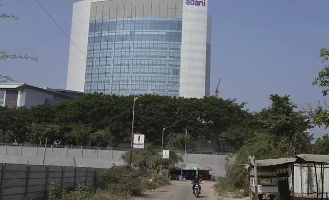 A motorcyclist ride past the Adani's corporate house in Ahmedabad, India, Thursday, Nov. 21, 2024. (AP Photo/Ajit Solanki)