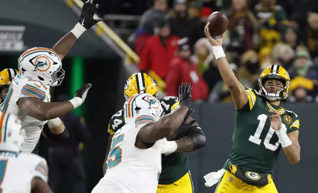 Green Bay Packers quarterback Jordan Love (10) throws a pass during the first half of an NFL football game against the Miami Dolphins Thursday, Nov. 28, 2024, in Green Bay, Wis. (AP Photo/Mike Roemer)