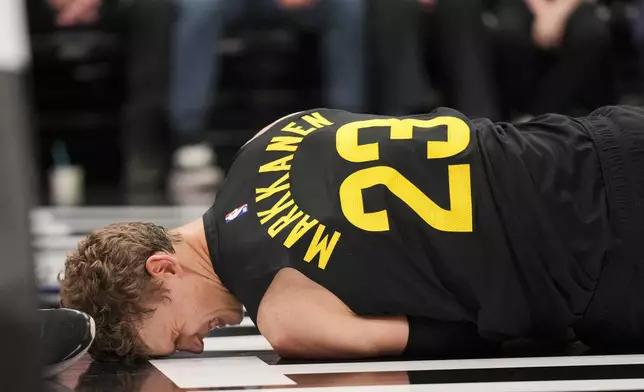 Utah Jazz forward Lauri Markkanen (23) reacts to an injury during the second half of an NBA basketball game against the San Antonio Spurs, on Tuesday, Nov. 26, 2024, in Salt Lake City. (AP Photo/Bethany Baker)