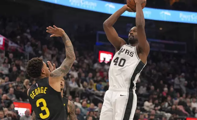 San Antonio Spurs forward Harrison Barnes (40) shoots as Utah Jazz guard Keyonte George (3) defends during the second half of an NBA basketball game, on Tuesday, Nov. 26, 2024, in Salt Lake City. (AP Photo/Bethany Baker)