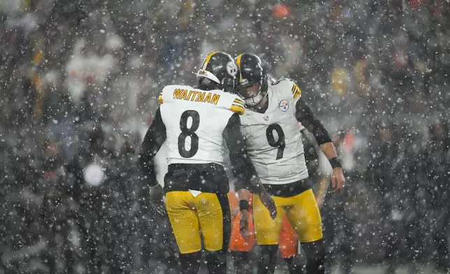 Pittsburgh Steelers place kicker Chris Boswell (9) celebrates with holder Corliss Waitman (8) in the second half of an NFL football game, Thursday, Nov. 21, 2024, in Cleveland. (AP Photo/Sue Ogrocki)