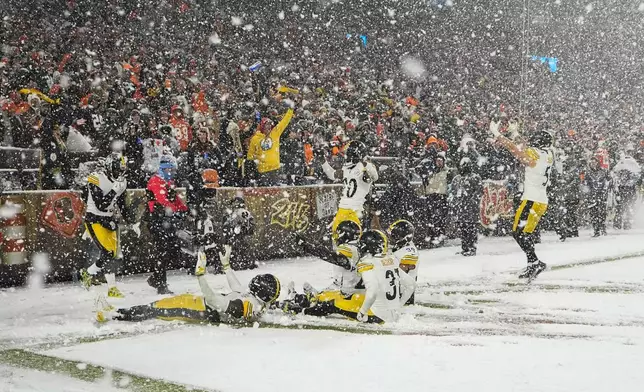 The Pittsburgh Steelers celebrate an interception in the second half of an NFL football game against the Cleveland Browns, Thursday, Nov. 21, 2024, in Cleveland. (AP Photo/Sue Ogrocki)