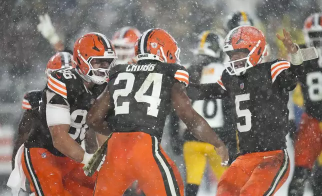 Cleveland Browns running back Nick Chubb (24) celebrates his touchdown with quarterback Jameis Winston (5) and tight end Blake Whiteheart (86) in the second half of an NFL football game against the Pittsburgh Steelers, Thursday, Nov. 21, 2024, in Cleveland. (AP Photo/Sue Ogrocki)