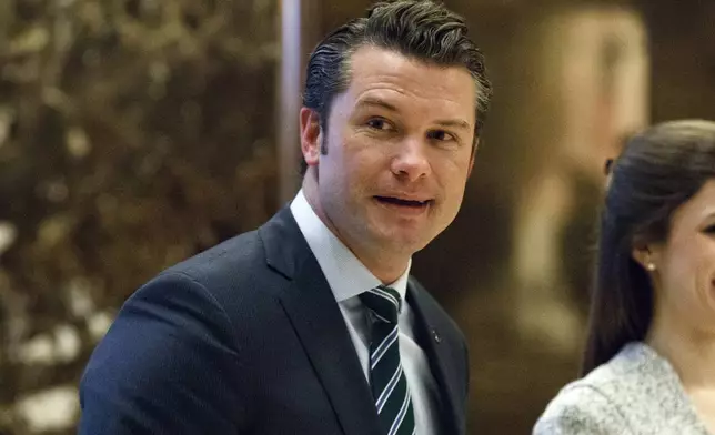 FILE - Pete Hegseth walks to an elevator for a meeting with President-elect Donald Trump at Trump Tower in New York, Dec. 15, 2016. (AP Photo/Evan Vucci, File)