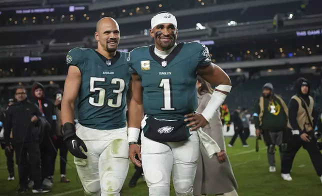 Philadelphia Eagles quarterback Jalen Hurts (1) and linebacker Zack Baun (53) head off the field following an NFL football game against the Washington Commanders Thursday, Nov. 14, 2024, in Philadelphia. The Eagles won 26-18. (AP Photo/Matt Slocum)