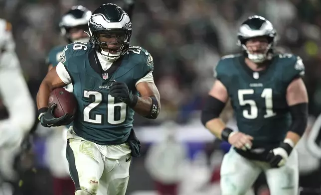 Philadelphia Eagles running back Saquon Barkley (26) runs for a touchdown during the second half of an NFL football game against the Washington Commanders Thursday, Nov. 14, 2024, in Philadelphia. (AP Photo/Matt Slocum)