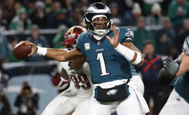 Philadelphia Eagles quarterback Jalen Hurts throws during the first half of an NFL football game against the Washington Commanders Thursday, Nov. 14, 2024, in Philadelphia. (AP Photo/Laurence Kesterson)