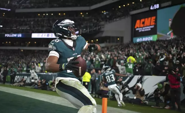 Philadelphia Eagles running back Saquon Barkley (26) celebrates after scoring during the second half of an NFL football game against the Washington Commanders Thursday, Nov. 14, 2024, in Philadelphia. (AP Photo/Matt Slocum)