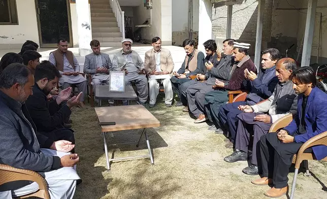 People offer prayer for local journalist Janan Hussain, who was killed in a gunmen firing incident, at his home, in Parachinar, main town of Kurram district of Pakistan's northwestern Khyber Pakhtunkhwa province, Friday, Nov. 22, 2024. (AP Photo/Hussain Ali)