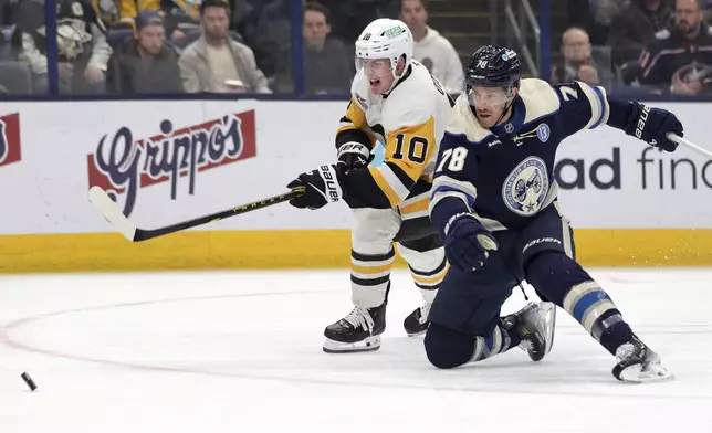 Columbus Blue Jackets defenseman Damon Severson, right, collides with Pittsburgh Penguins forward Drew O'Connor during the first period of an NHL hockey game in Columbus, Ohio, Friday, Nov. 15, 2024. (AP Photo/Paul Vernon)