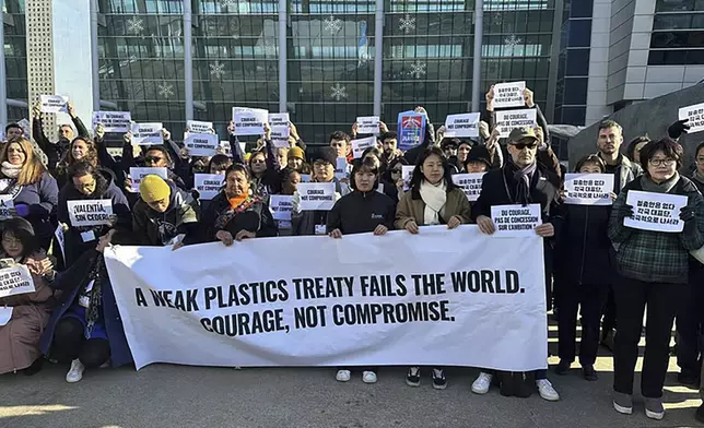 Environment activists hold a press conference calling for a strong global plastics treaty outside of the venue for the fifth session of the Intergovernmental Negotiating Committee on Plastic Pollution in Busan, South Korea, Friday, Nov. 29, 2024. (AP Photo/Jennifer McDermott)