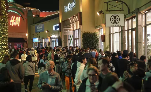 Early Black Friday shoppers line up outside stores at Citadel Outlets in Commerce, Calif., Thursday, Nov. 28, 2024. (AP Photo/Jae C. Hong)
