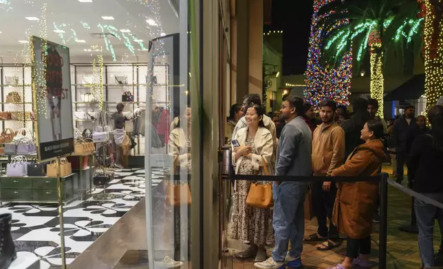 Early Black Friday shoppers line up outside stores at Citadel Outlets in Commerce, Calif., Thursday, Nov. 28, 2024. (AP Photo/Jae C. Hong)