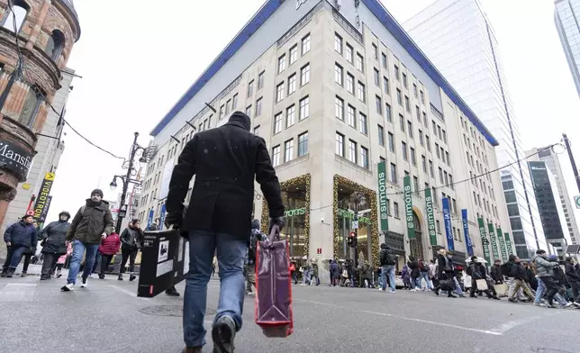 Shoppers take advantage of Black Friday deals in Montreal on Friday, Nov. 29, 2024. (Christinne Muschi /The Canadian Press via AP)