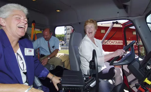 FILE - Gov. M. Jodi Rell, right, enjoys a laugh as she sits in the driver's seat of a new Homeland Security Vehicle with Dept. of Enviromental Protection Commissioner Gina McCarthy, left, in Windsor Locks, Conn., June 20, 2005. (AP Photo/ Steven Lee Miller, File)