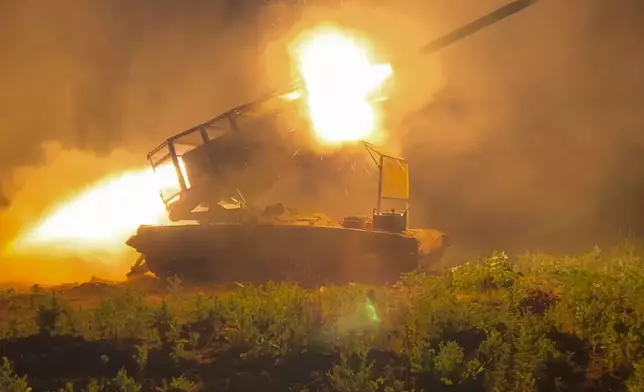 In this photo taken from a video released by Russian Defense Ministry press service on Wednesday, Nov. 13, 2024, the Russian army's multiple rocket launcher Solntsepyok fires towards Ukrainian positions in the border area of Kursk region, Russia. (Russian Defense Ministry Press Service via AP)