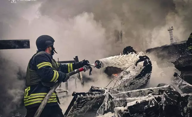 In this photo provided by the Ukrainian Emergency Service on Nov. 13, 2024, rescue workers extinguish a fire of a building destroyed by a Russian strike in Brovary, outside Kyiv, Ukraine. (Ukrainian Emergency Service via AP)