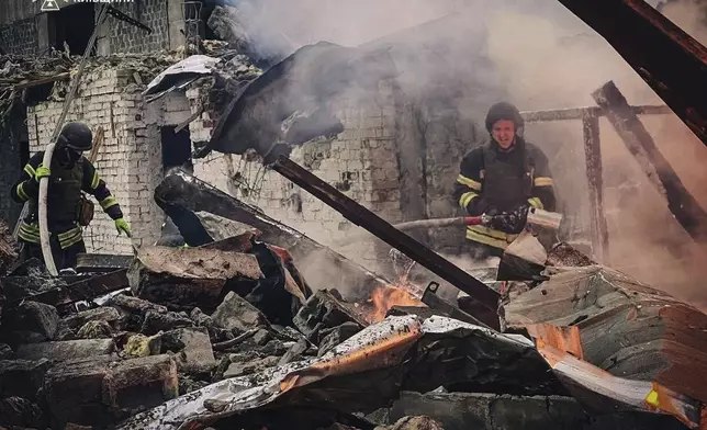 In this photo provided by the Ukrainian Emergency Service on Nov. 13, 2024, rescue workers extinguish a fire of a building destroyed by a Russian strike in Brovary, outside Kyiv, Ukraine. (Ukrainian Emergency Service via AP)