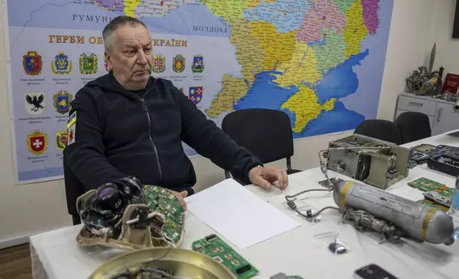 Andrii Kulchytskyi the head of the military research laboratory at the Kyiv Scientific Research Institute of Forensic Expertise sits in his workspace in Kyiv, Ukraine, Tuesday, Oct. 15, 2024. (AP Photo/Alex Babenko)