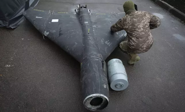 A Ukrainian officer examines a downed Shahed drone with thermobaric charge launched by Russia in a research laboratory in an undisclosed location in Ukraine Thursday, Nov. 14, 2024. (AP Photo/Efrem Lukatsky)