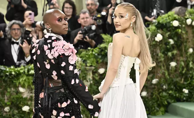 FILE - Cynthia Erivo, left, and Ariana Grande attend The Metropolitan Museum of Art's Costume Institute benefit gala celebrating the opening of the "Sleeping Beauties: Reawakening Fashion" exhibition on Monday, May 6, 2024, in New York. In “Wicked,” Elphaba and Glinda travel from Shiz University to the Emerald City on a glistening green train to meet the wizard. In real life, Cynthia Erivo and Ariana Grande have traveled much farther and wider and longer and on airplanes to promote their hotly anticipated film. (Photo by Evan Agostini/Invision/AP, File)