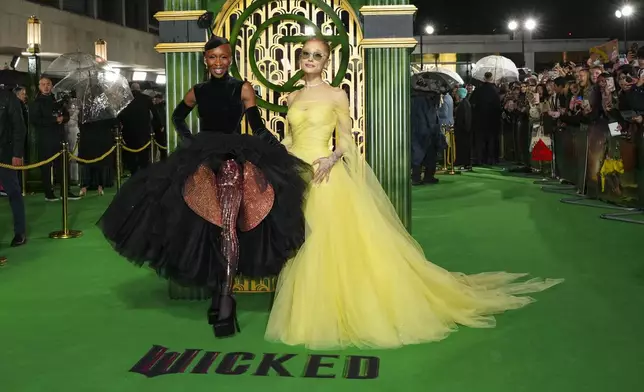 FILE - Cynthia Erivo, left, and Ariana Grande pose for photographers upon arrival at the premiere of the film 'Wicked' on Monday, Nov. 18, 2024, in London. In “Wicked,” Elphaba and Glinda travel from Shiz University to the Emerald City on a glistening green train to meet the wizard. In real life, Cynthia Erivo and Ariana Grande have traveled much farther and wider and longer and on airplanes to promote their hotly anticipated film. (Photo by Scott A Garfitt/Invision/AP, File)