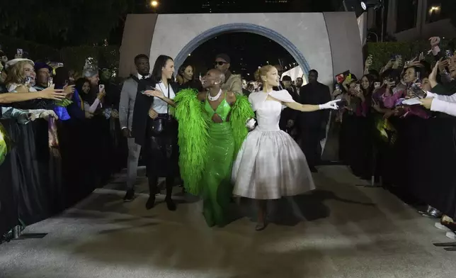 FILE - Cynthia Erivo, left, and Ariana Grande arrive at the premiere of "Wicked" on Saturday, Nov. 9, 2024, at Dorothy Chandler Pavilion in Los Angeles. In “Wicked,” Elphaba and Glinda travel from Shiz University to the Emerald City on a glistening green train to meet the wizard. In real life, Cynthia Erivo and Ariana Grande have traveled much farther and wider and longer and on airplanes to promote their hotly anticipated film. (Photo by Jordan Strauss/Invision/AP, File)