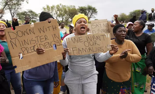 Relatives and friends protest near a reformed gold mineshaft where illegal miners are trapped in Stilfontein, South Africa, Friday, Nov. 15, 2024. (AP Photo/Denis Farrell)