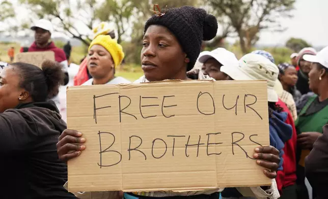 Relatives and friends protest near a reformed gold mineshaft where illegal miners are trapped in Stilfontein, South Africa, Friday, Nov. 15, 2024. (AP Photo/Denis Farrell)