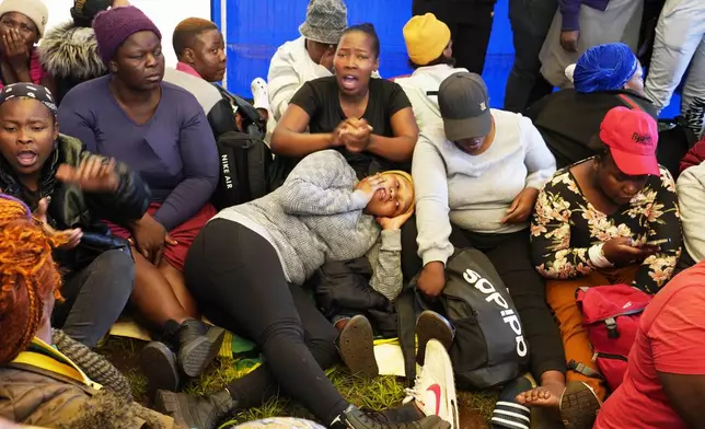 Relatives and friends wait for news near a reformed gold mineshaft where illegal miners are trapped in Stilfontein, South Africa, Friday, Nov. 15, 2024. (AP Photo/Denis Farrell)