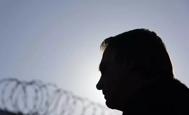 FILE - In a silhouette, Brazil's former President Jair Bolsonaro speaks to the media upon arrival to the airport in Brasilia, Brazil, June 29, 2023, where Supreme Electoral Court judges evaluate the case which claims he abused his power by using government communication channels to promote his campaign and cast unfounded doubts on the country's electronic voting system. (AP Photo/Eraldo Peres, File)