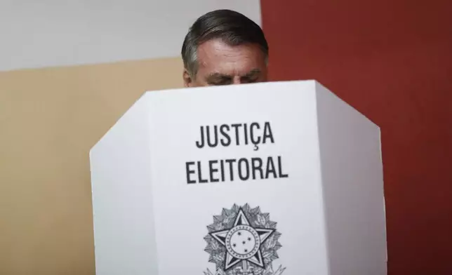 FILE - Brazilian President Jair Bolsonaro votes in the run-off presidential election as he runs for another term in Rio de Janeiro, Brazil, Oct. 30, 2022. (AP Photo/Bruna Prado, Pool, File)