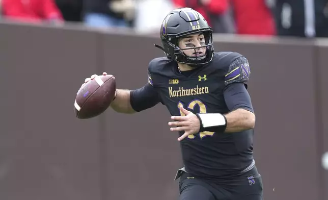 Northwestern quarterback Jack Lausch passes during the first half of an NCAA college football game against Ohio State at Wrigley Field on Saturday, Nov. 16, 2024, in Chicago. (AP Photo/Charles Rex Arbogast)