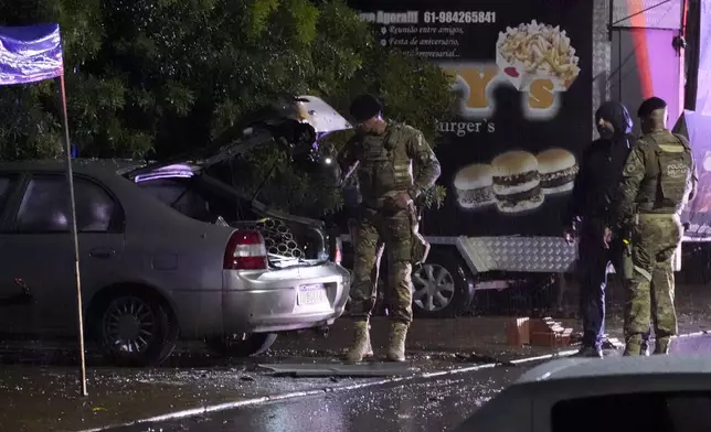 Police inspect a vehicle outside the Supreme Court in Brasília, Brazil, following an explosion, Wednesday, Nov. 13, 2024. (AP Photo/Eraldo Peres)