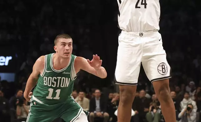 Brooklyn Nets' Cam Thomas shoots while Boston Celtics' Payton Pritchard defends in the first half of an NBA basketball game, Wednesday, Nov. 13, 2024, in New York. (AP Photo/Heather Khalifa)