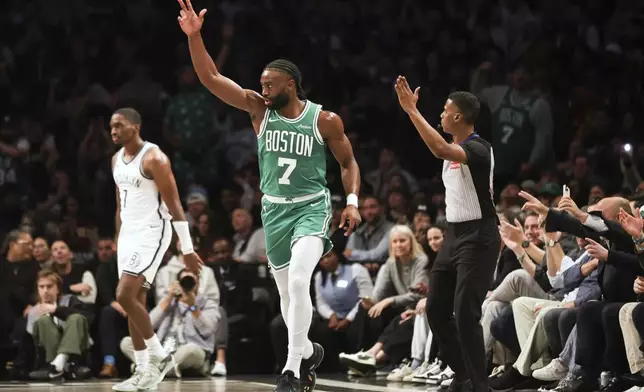 Boston Celtics' Jaylen Brown reacts after scoring a three-point basket in the first half of an NBA basketball game against the Brooklyn Nets, Wednesday, Nov. 13, 2024, in New York. (AP Photo/Heather Khalifa)