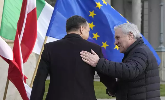 Italy's Foreign Minister Antonio Tajani, right, is welcomed by Poland's Foreign Minister Radoslaw Sikorski upon arrival for a meeting of European foreign ministers, in Warsaw, Tuesday, Nov. 19, 2024. (AP Photo/Czarek Sokolowski)